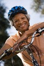 older african american woman leaning on bike handle bars