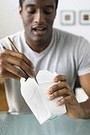 african american man eating chinese food