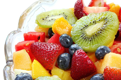 A bowl of fruit salad with honey dressing