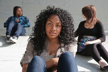 A teen girl sitting with her friends