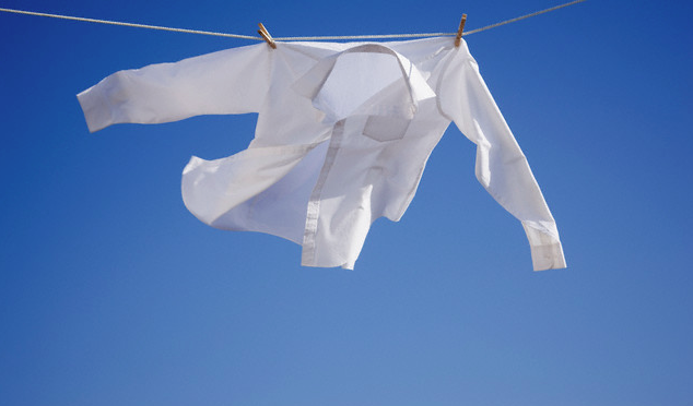 A white shirt hanging on a clothes-line