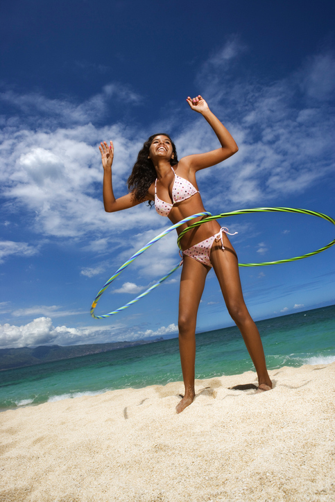 Teenage girl with hoops on beach