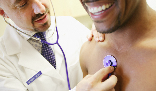 A doctor examining a patient's heart with a stethoscope