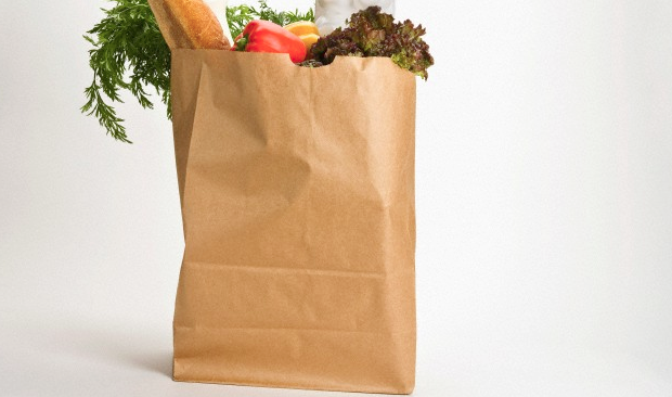 A large brown paper bag filled with groceries