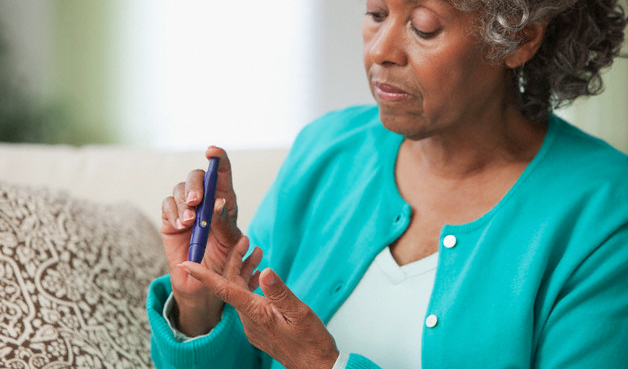 A diabetic woman testing her blood glucose level