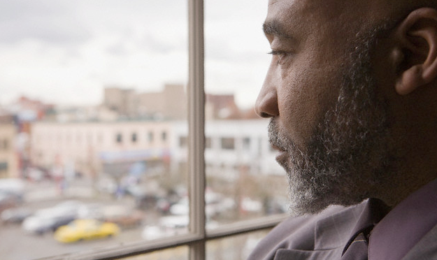 older african american man looking out of window