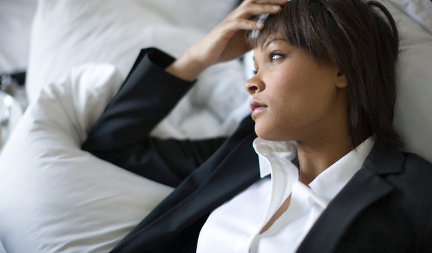 A businesswoman resting against a pillow