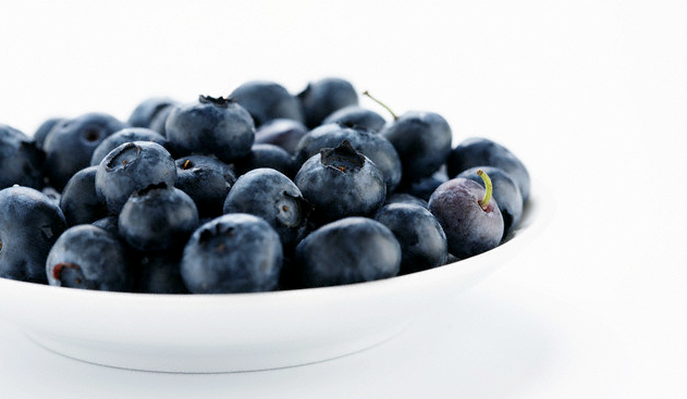 A white bowl filled with blueberries