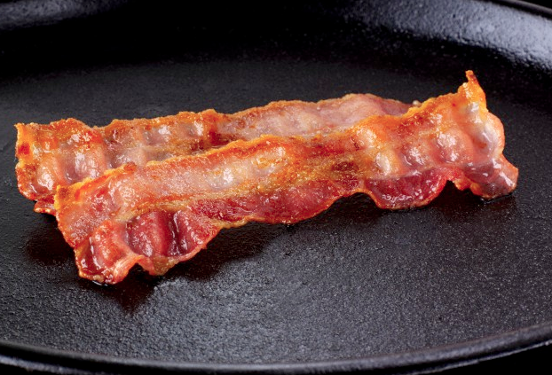 Two strips of bacon in a skillet