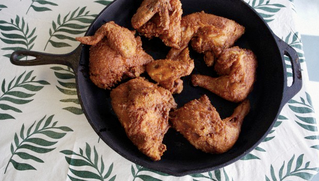 Pieces of fried chicken in a skillet