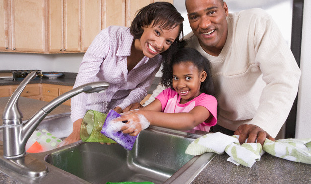 A family cleaning their kitchen