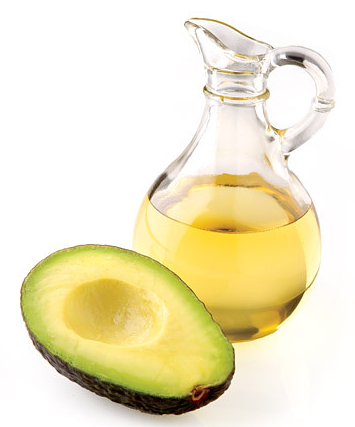 A sliced avocado and a jar of avocado oil