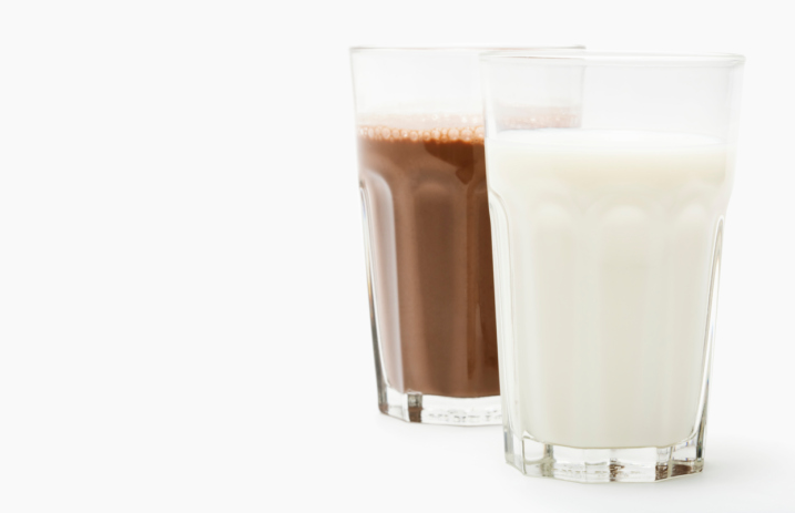 Two glasses of regular and chocolate milk
