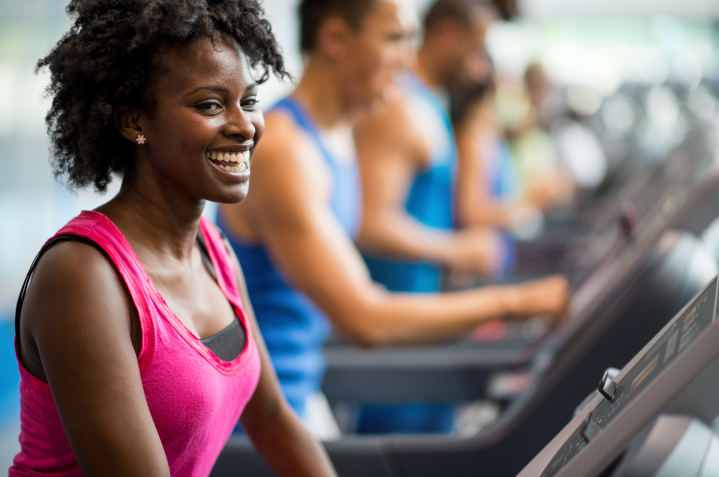A smiling woman on the treadmill at the gym