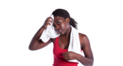 african american woman wiping sweat off her head