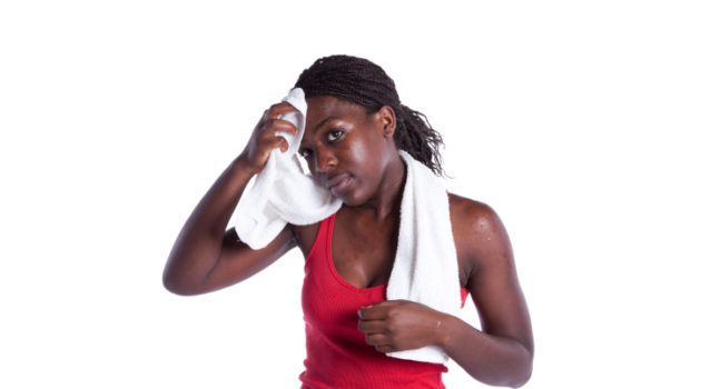 african american woman wiping sweat off her head