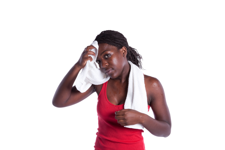 african american woman wiping sweat off her head