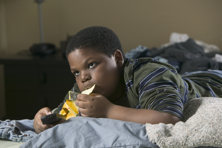 African American boy eating chips