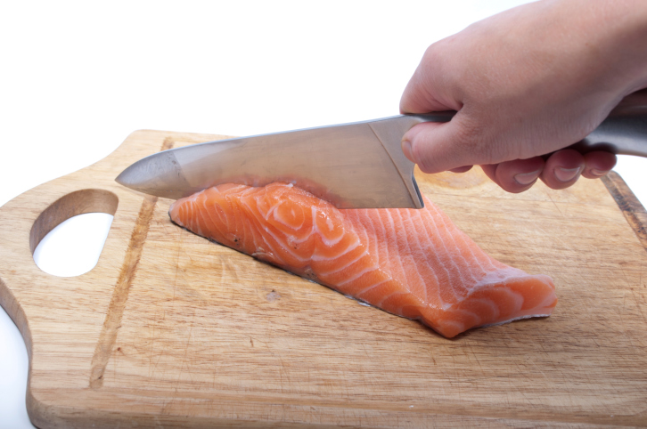 cutting salmon on a cutting board