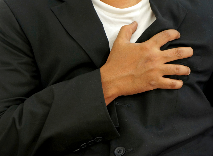 man clutching chest