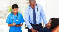 african doctor examining female patient