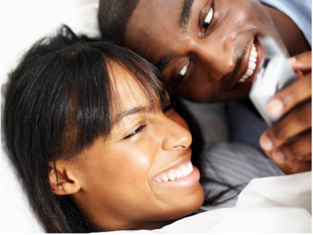 couple phone bed