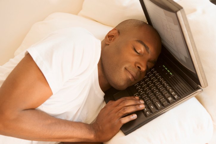 man sleeping on laptop