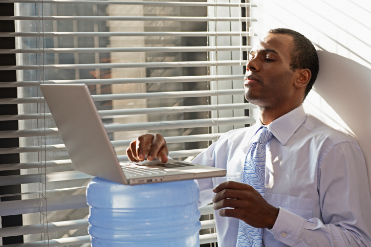 man typing while standing