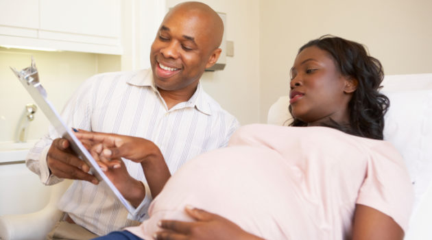 Pregnant Woman Being Given Ante Natal Check By Doctor