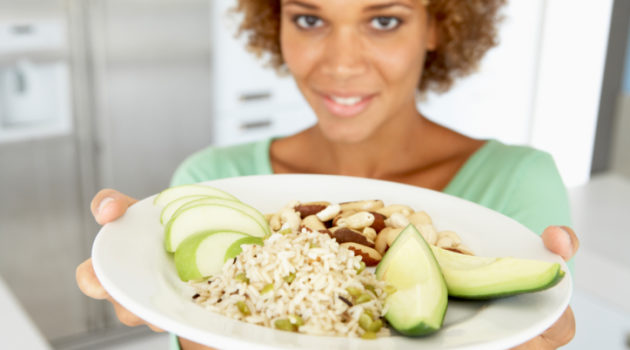 adult woman holding plate of food