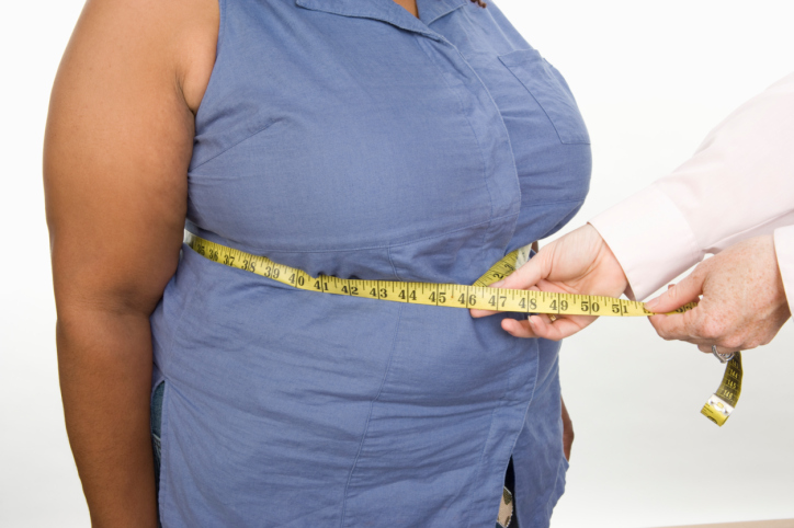 Doctor taking measures of overweight mid-adult woman