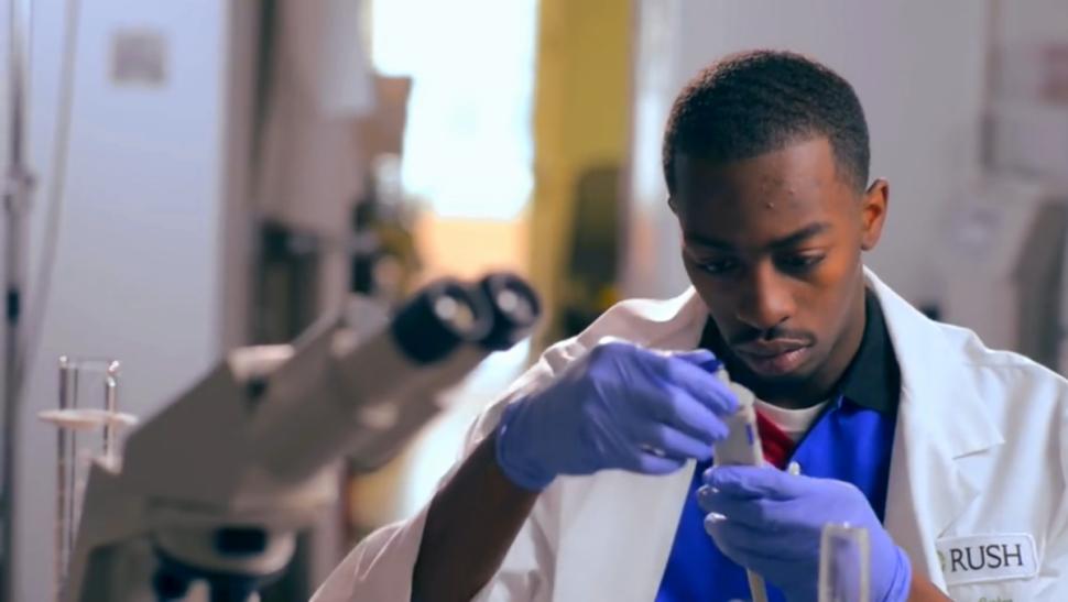 black man looking at testing tube