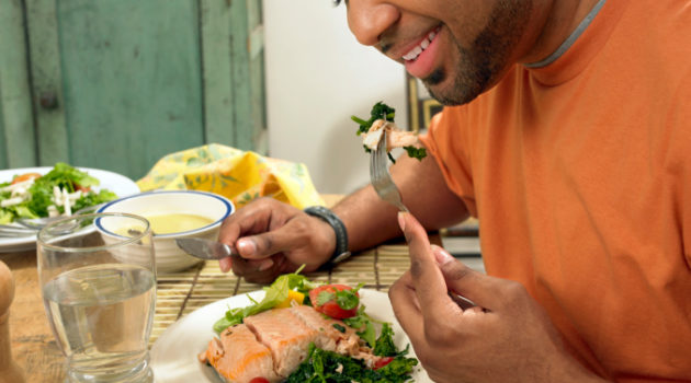 man eating a salmon salad for lunch