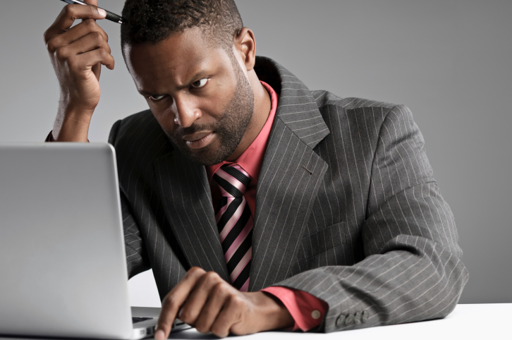 Man In Suit Concentrating On Laptop