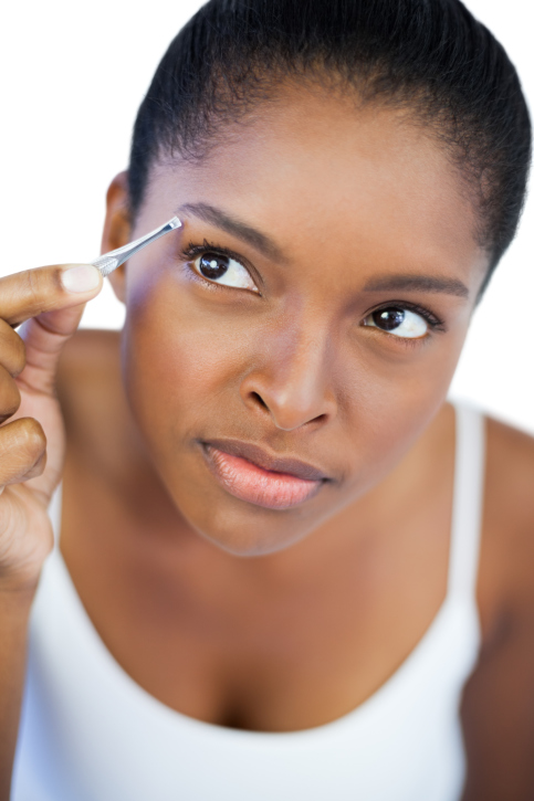 woman tweezer eyebrows