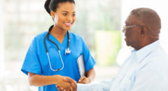 african american medical nurse handshaking with senior patient