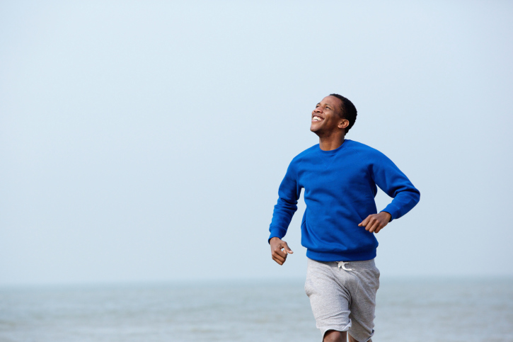 man jogging on beach