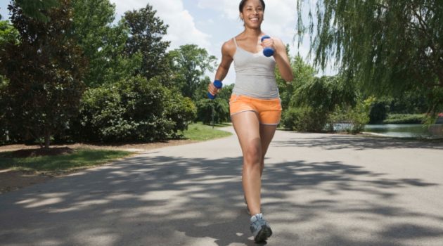African American woman running in street sunny day