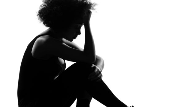 silhouette of woman sitting on ground