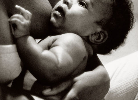 African American mother breastfeeding her baby boy
