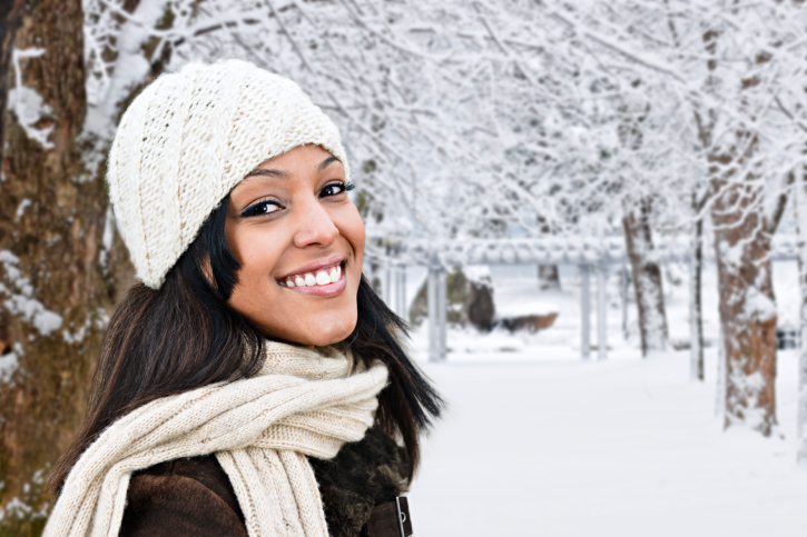 smiling african american woman standing outside in the winter