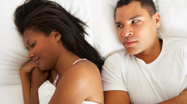 couple in bed with relationship difficulties