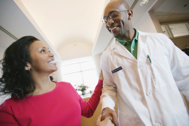 African American Black woman shaking doctors hand