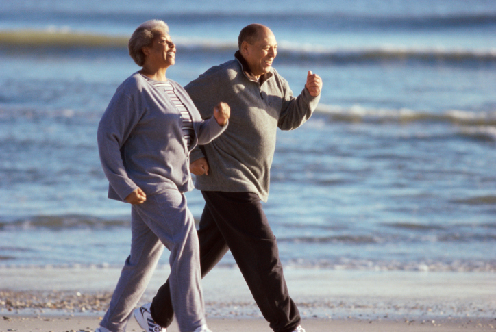 older couple walking on beach