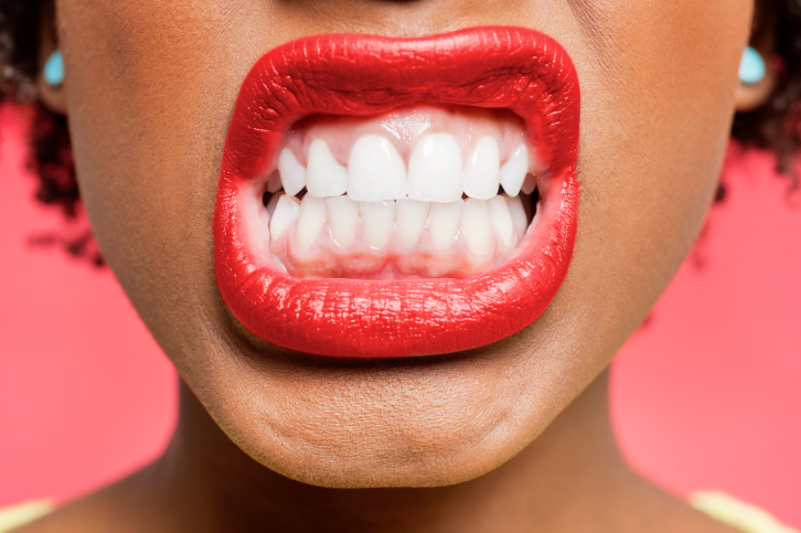 Detail shot of woman clenching teeth