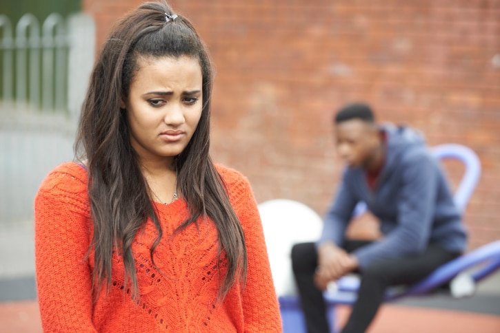 Portrait Of Unhappy Teenage Couple In Urban Setting
