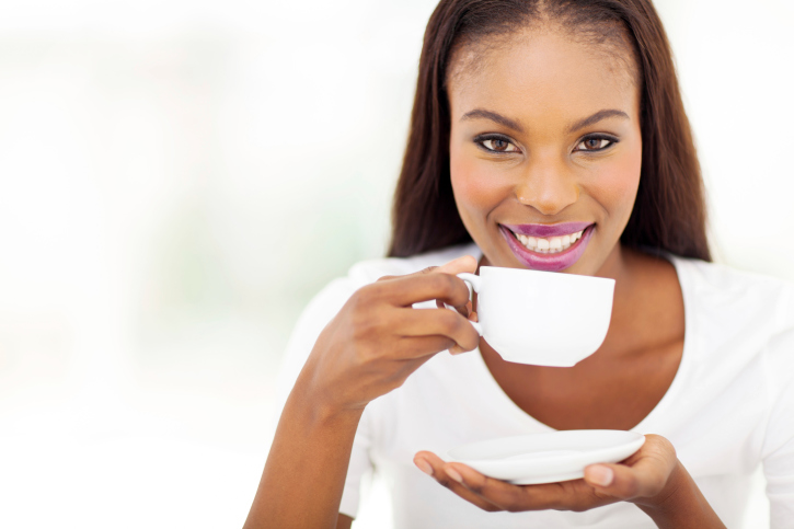african american woman drinking coffee or tea