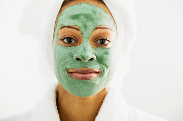portrait of a young woman getting a facial