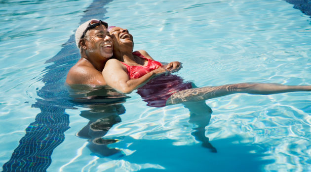 African American senior couple in swimming pool