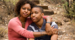 african american woman with her arm around her son